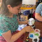 Hand-beading heart pins in Guatemala