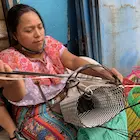 Weaving a plastic basket in rural Guatemala